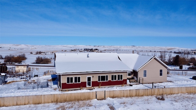 snow covered property featuring fence