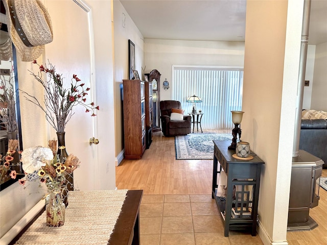 hall featuring wood finished floors and baseboards