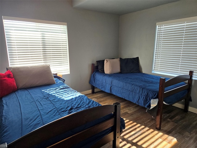 bedroom featuring dark wood-type flooring and baseboards