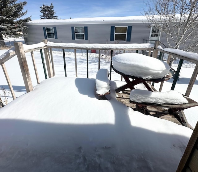 view of snow covered back of property