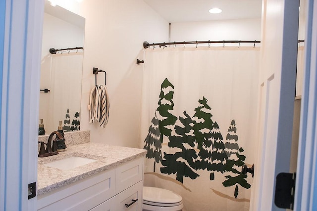 full bathroom featuring vanity and toilet