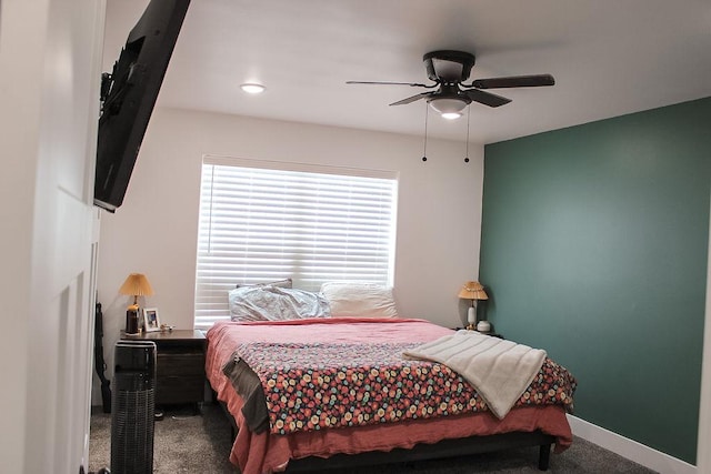 carpeted bedroom featuring a ceiling fan and baseboards