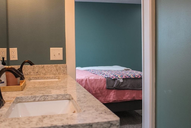 bathroom featuring a sink and double vanity