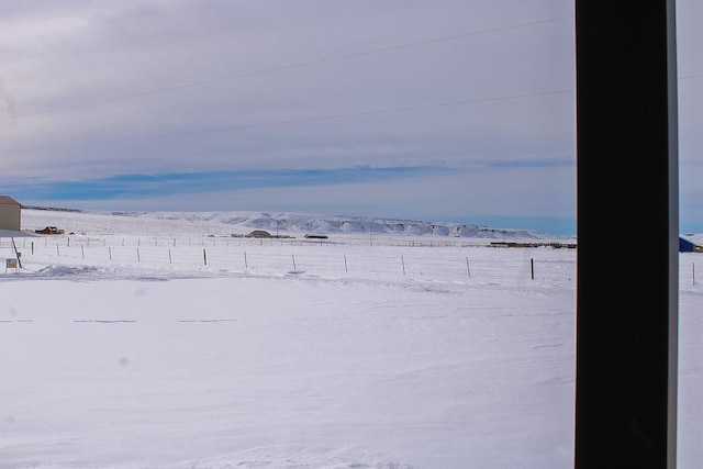 snowy yard with a mountain view