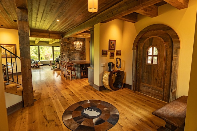 foyer entrance with beam ceiling, light wood finished floors, recessed lighting, wood ceiling, and stairs