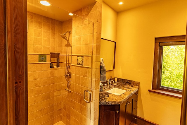 bathroom with a stall shower, recessed lighting, and vanity