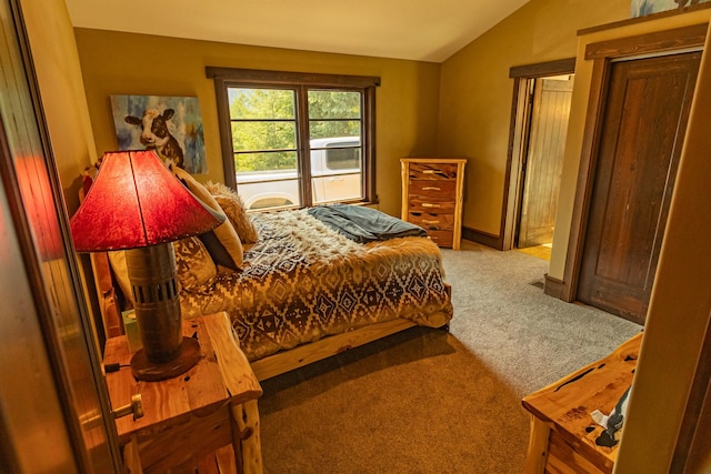 carpeted bedroom featuring lofted ceiling and baseboards