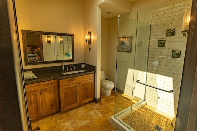 full bathroom with toilet, a shower stall, and vanity