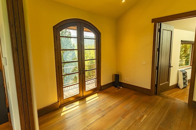 entryway with light wood-type flooring, french doors, and plenty of natural light