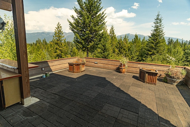 view of patio / terrace featuring a mountain view