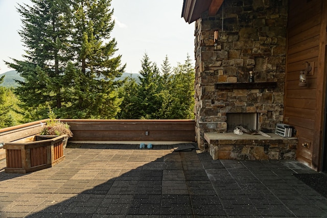 view of patio / terrace featuring an outdoor stone fireplace