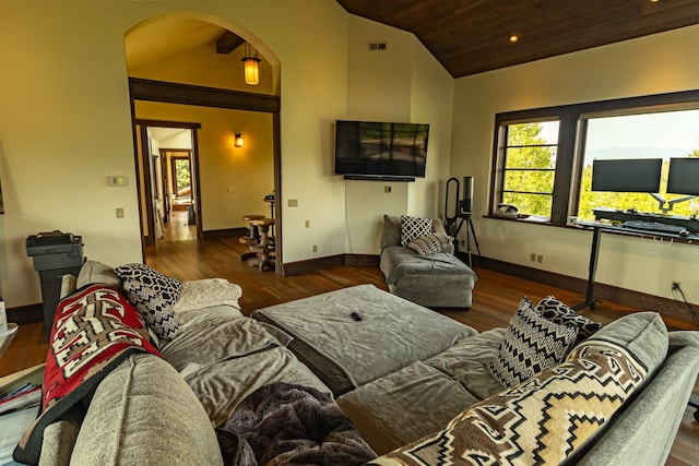 living room with lofted ceiling, visible vents, arched walkways, and dark wood finished floors