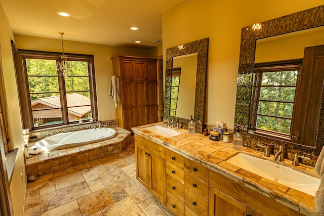 full bath with a healthy amount of sunlight, a sink, and double vanity