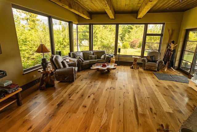 unfurnished sunroom featuring beamed ceiling and wood ceiling