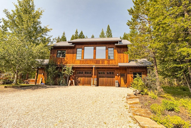 view of front of house with gravel driveway and a garage