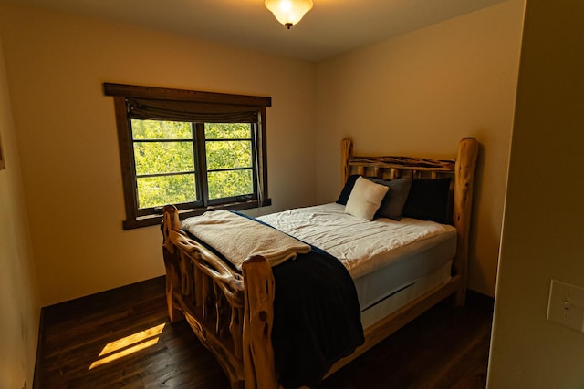 bedroom with dark wood finished floors