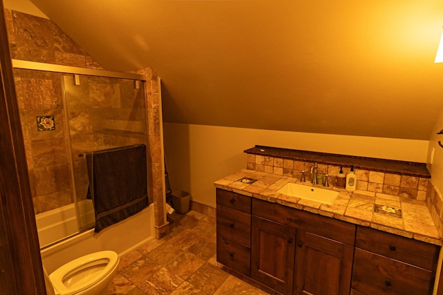 full bathroom featuring shower / bath combination with glass door, vaulted ceiling, vanity, and toilet