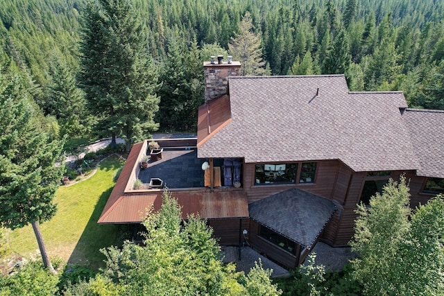 drone / aerial view featuring a forest view