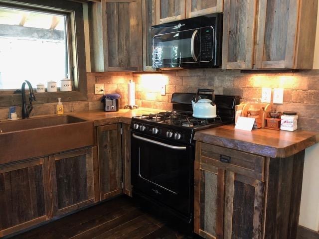 161 Tanglewood Ln, Whitefish, MT 59937 - kitchen with black appliances, backsplash, and dark wood-style flooring