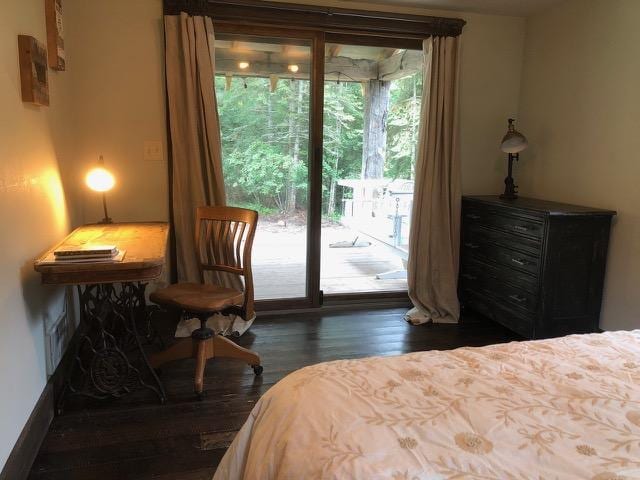 161 Tanglewood Ln, Whitefish, MT 59937 - bedroom with access to exterior and dark wood-style flooring