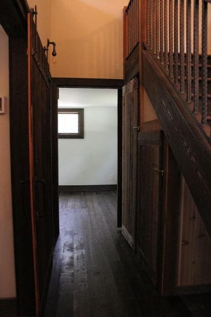 161 Tanglewood Ln, Whitefish, MT 59937 - hallway with dark wood finished floors and a barn door