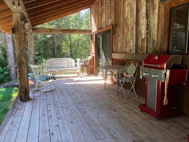 wooden deck featuring a grill