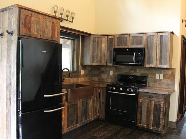 161 Tanglewood Ln, Whitefish, MT 59937 - kitchen with black appliances, tasteful backsplash, and dark wood-style floors