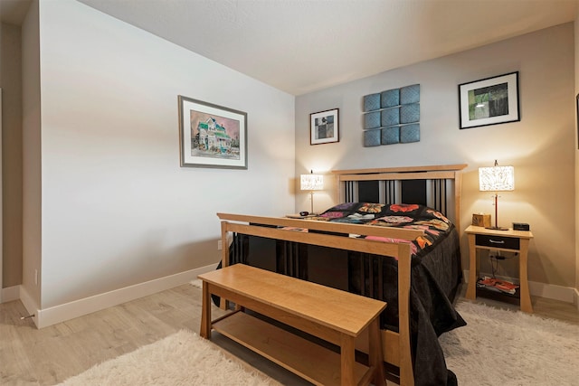 bedroom featuring light wood-style flooring and baseboards