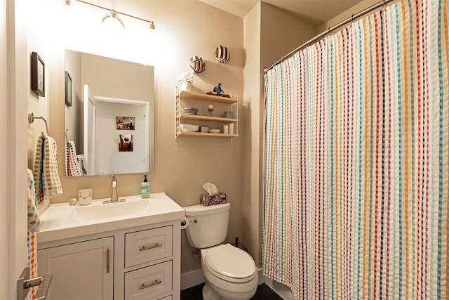 bathroom featuring toilet, a shower with curtain, and vanity