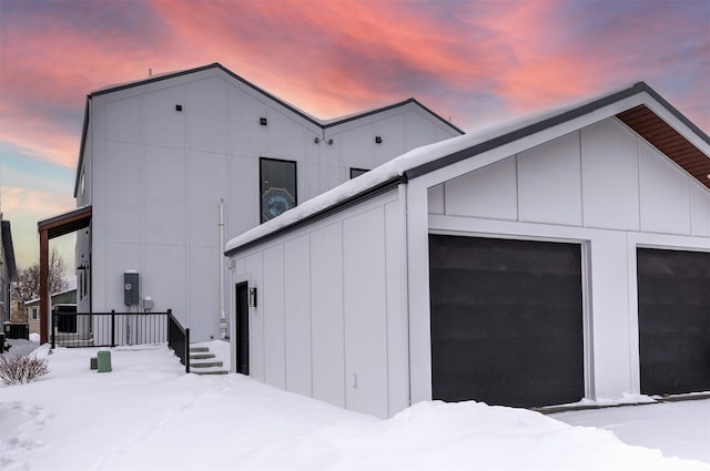 2028B Burlington Ave, Missoula, MT 59801 - view of snow covered exterior with board and batten siding and a garage