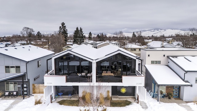 view of snow covered back of property