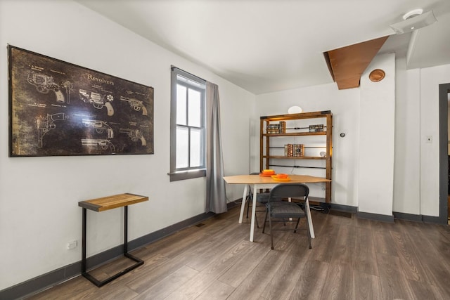 office area with dark wood-type flooring and baseboards