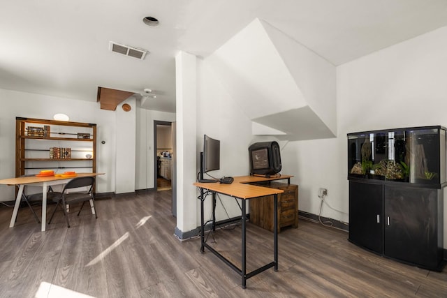 office featuring baseboards, visible vents, and dark wood-type flooring