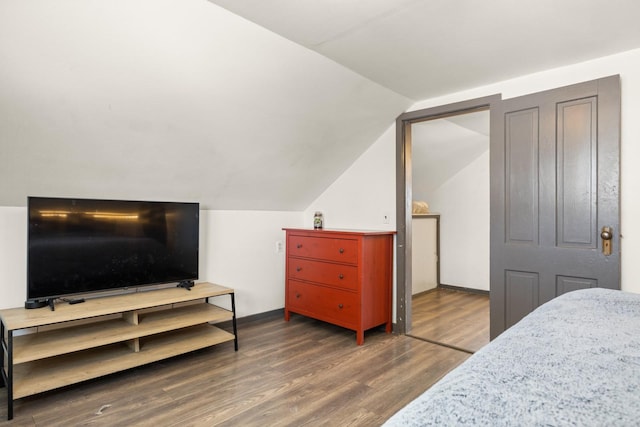 bedroom featuring vaulted ceiling and dark wood-type flooring