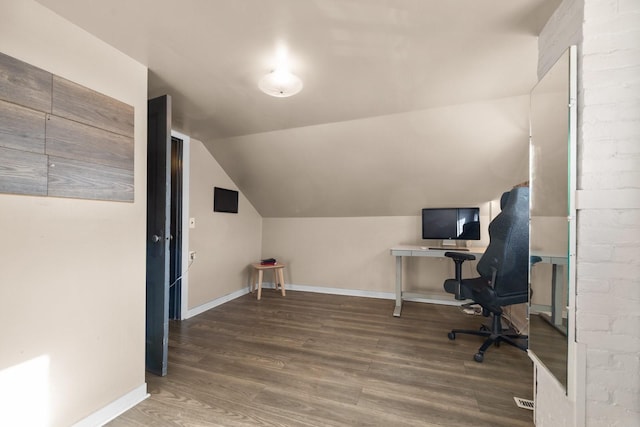 office area featuring vaulted ceiling, dark wood finished floors, and baseboards