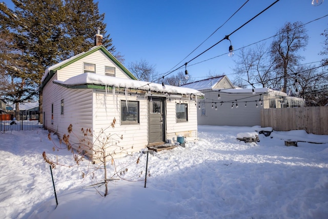 snow covered property featuring fence