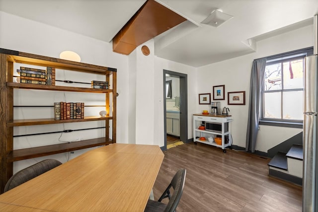 office area with dark wood-style floors and baseboards