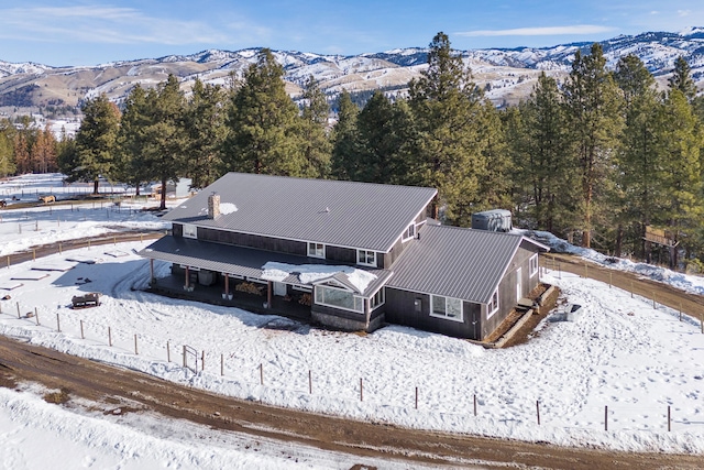 snowy aerial view featuring a mountain view