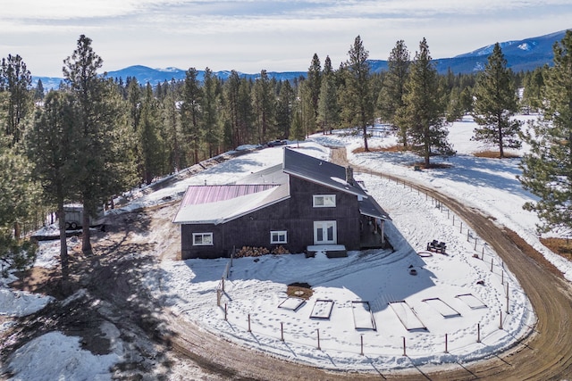 snowy aerial view with a mountain view