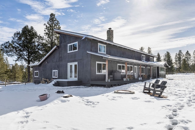 snow covered house with a chimney