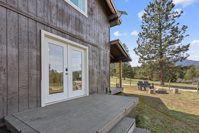 deck featuring a yard, french doors, and an outdoor fire pit