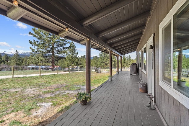 wooden terrace featuring a yard