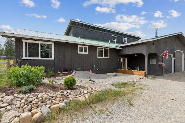 exterior space featuring metal roof, driveway, and an attached garage