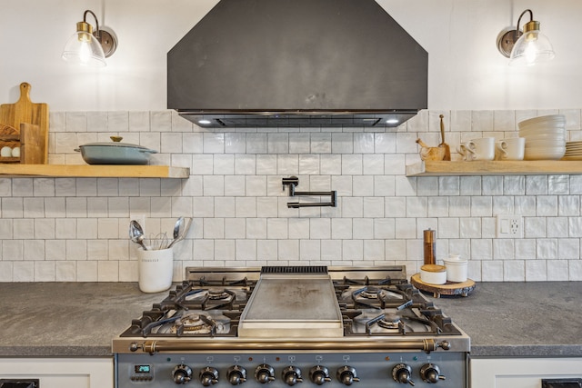 kitchen featuring white cabinetry, range hood, decorative backsplash, open shelves, and dark countertops