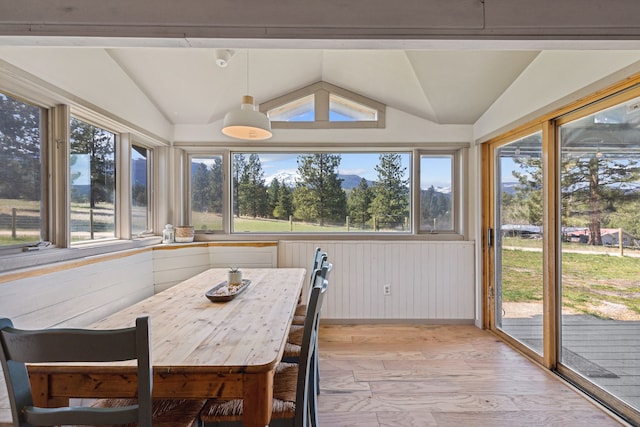 sunroom / solarium featuring vaulted ceiling