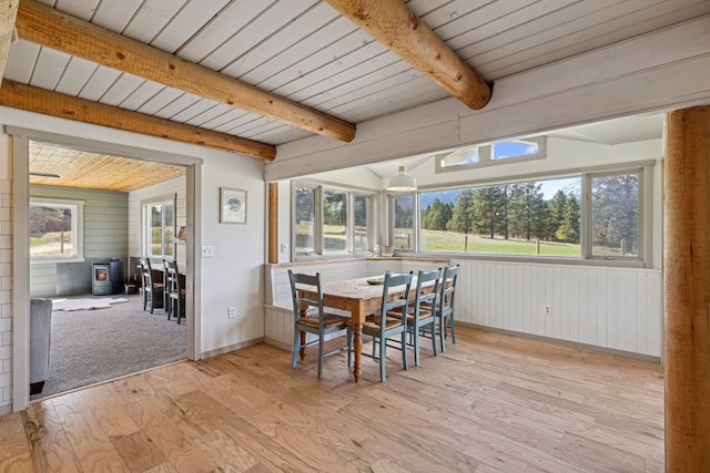 sunroom featuring beamed ceiling and wood ceiling