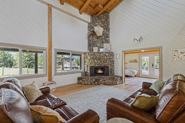 living room featuring wood ceiling, a fireplace, beamed ceiling, and wood finished floors