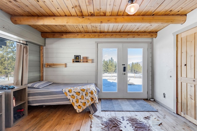 bedroom featuring light wood-style flooring, wood ceiling, access to exterior, french doors, and beam ceiling