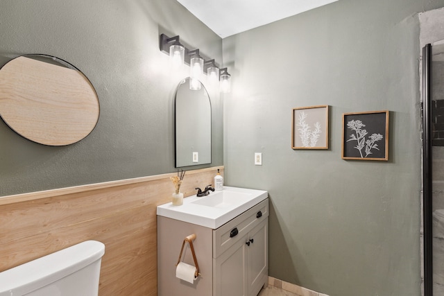 bathroom featuring toilet and vanity