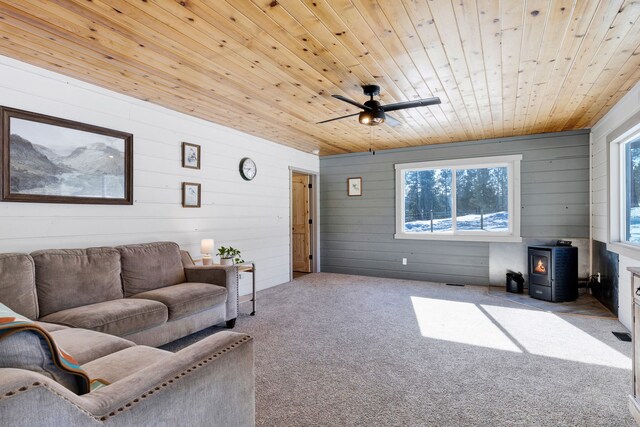 living area with light colored carpet, wood ceiling, and a healthy amount of sunlight